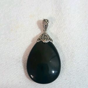 Sterling marquisite holding black onyx pendant